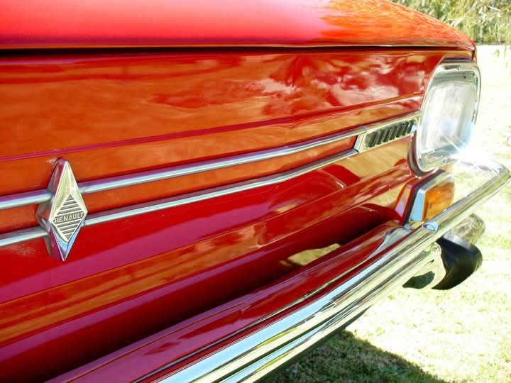 Detalle del frente y emblema de un Renault 10 rojo